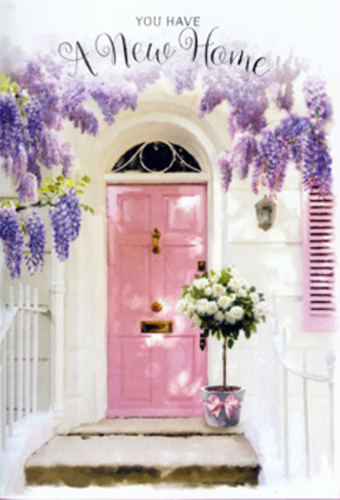 The photograph captures a quietly enchanting doorway that seems as though it could sit along one of Somers Town's calmer side streets, where historic terraces and modern flats mingle side by side. At the centre, a soft pink front door radiates a gentle warmth, its colour reminiscent of early evening light over nearby St Pancras. The door is framed by whitewashed walls that show a hint of texture, catching small shadows and highlights that add depth to the façade. A single shutter painted in a similarly tender pastel hue tilts open, hinting at life within. Above, wisteria tumbles down in abundant swathes, forming a natural arch across the top of the doorway. The blossoms are a blend of lavender, lilac, and muted purple, each raceme hanging in a soft, pendulous curve. The flowers look almost velvety, and you can imagine their sweet, powdery perfume drifting out into the air, mingling with the distant hum of traffic and footsteps from Euston Road. At the threshold, resting neatly on the step, sits a chic, dovetailed grey bucket overflowing with creamy white and ivory roses. The roses are full and plush, their layered petals unfolding like silk, each bloom slightly different, as if hand-chosen for its character. Interspersed among them, sprigs of soft greenery add contrast and a sense of freshness, hinting at stem textures and foliage shapes just out of full view. A soft pink ribbon, tied around the bucket in an elegant bow, visually connects the arrangement with the colour of the door. The mood is serene and hopeful, making this a perfect visual for a new home floral gift in Somers Town-an understated, beautiful way to say "congratulations" and bless a new doorway with beauty and calm.